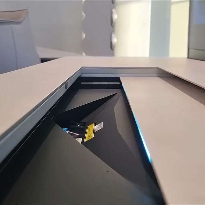 Concealed screen lift emerging from a bespoke console top