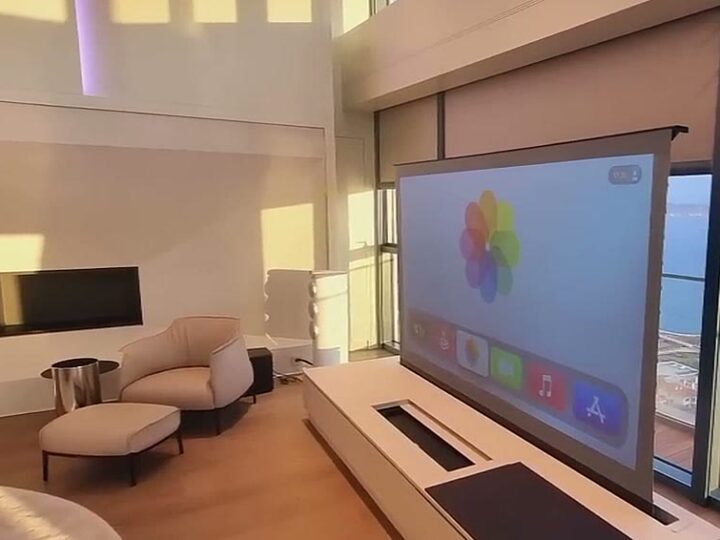 Durumetal motorised screen lift raised from a console in a sea-view penthouse living room