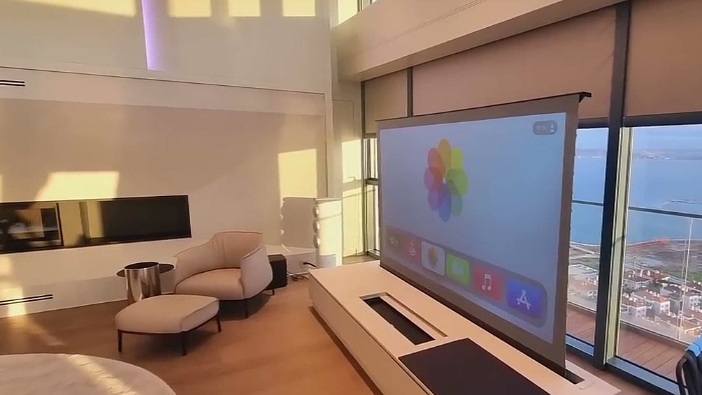 Durumetal motorised screen lift raised from a console in a sea-view penthouse living room
