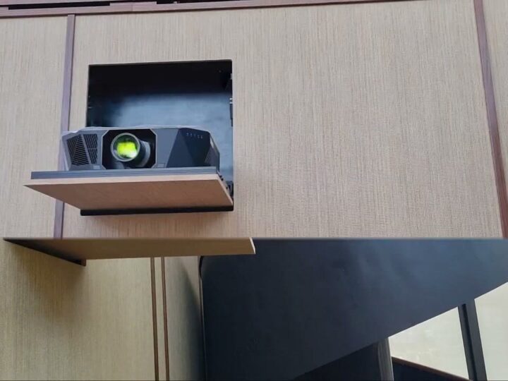 Durumetal hidden projector lift fully deployed from a concealed wood-panelled wall